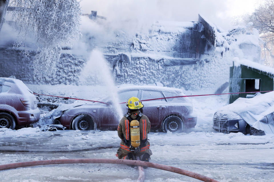 Firefighters battle a five-alarm fire in an apartment building on a frigid winter day in Montreal on Feb. 3, 2023. (Ryan Remiorz/The Canadian Press via AP)