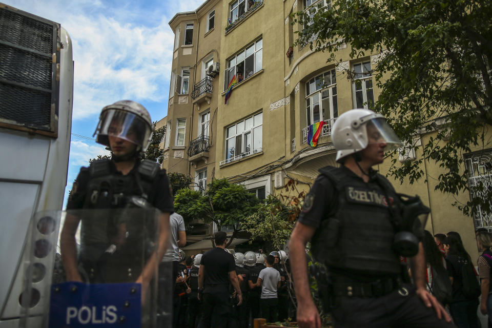 FILE - People display rainbow flags as Turkish police officers cordon off an area during the LGBTQ Pride March in Istanbul, Turkey, on June 26, 2022. A six-party opposition alliance united behind the candidacy of Kemal Kilicdaroglu have declared their commitment for a return to parliamentary democracy and greater rights and freedoms should their alliance win the elections. (AP Photo/Emrah Gurel, File)