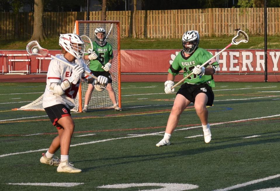 A Cherry Hill East player eyes defenders from West Deptford High School during an April 29 boys lacrosse game at East's new stadium.