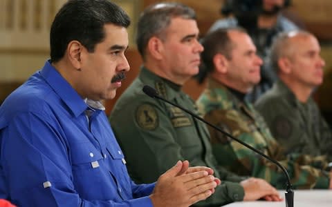 Maduro appears flanked by Venezuela's Defence Minister and two top military commanders in a photo released on Tuesday by the Miraflores Press Office