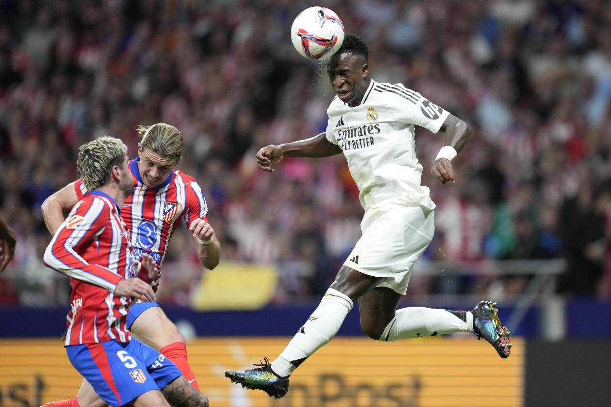 Real Madrid's Vinicius Junior goes for a header during the La Liga soccer match between Atletico Madrid and Real Madrid at the Metropolitano stadium in Madrid, Spain, Sunday, Sept. 29, 2024. (AP Photo/Bernat Armangue)