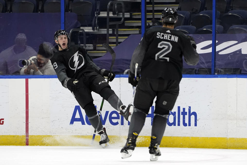 Tampa Bay Lightning left wing Ross Colton (79) celebrates his goal against the Detroit Red Wings with defenseman Luke Schenn (2) during the first period of an NHL hockey game Saturday, April 3, 2021, in Tampa, Fla. (AP Photo/Chris O'Meara)