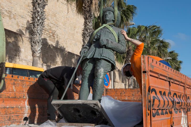 Local workers remove a statue of former Spanish dictator Francisco Franco in Spain