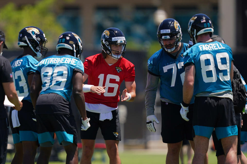 May 15, 2021; Jacksonville, Florida, USA; Jacksonville Jaguars quarterback Trevor Lawrence (16) calls a play in the huddle during rookie mini camp at TIAA Bank Field. Mandatory Credit: Jasen Vinlove-USA TODAY Sports