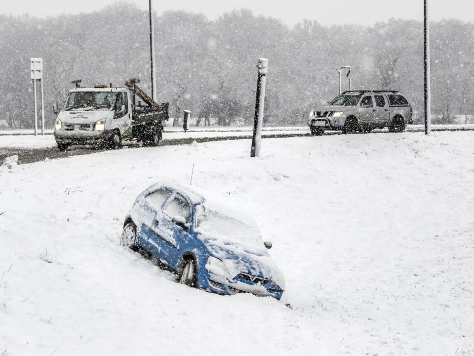 A car that has come off the road in snow in Bedale, North Yorkshire, on February 24, 2010: Danny Lawson/PA Wire