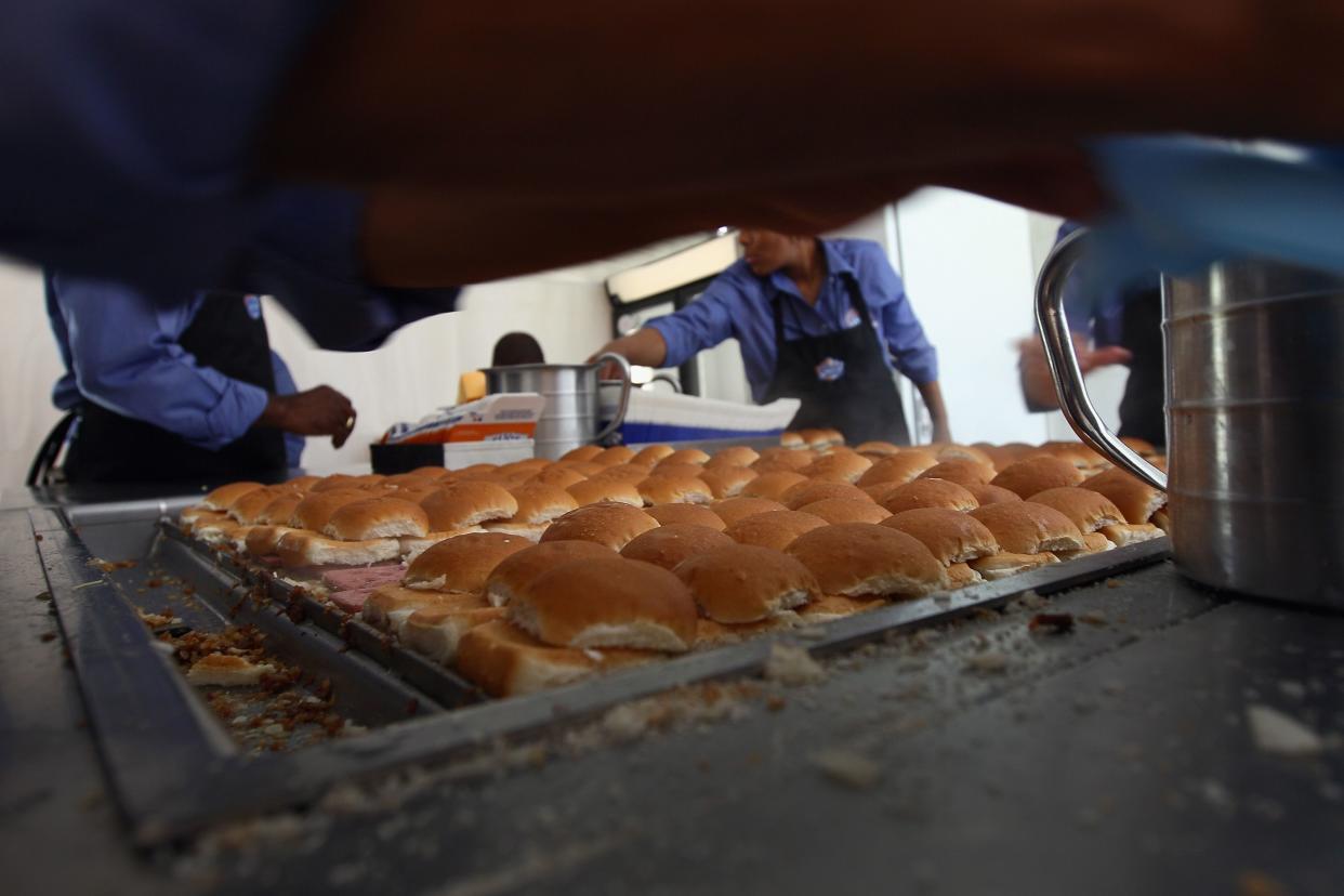 White Castle employees cook their slider burgers