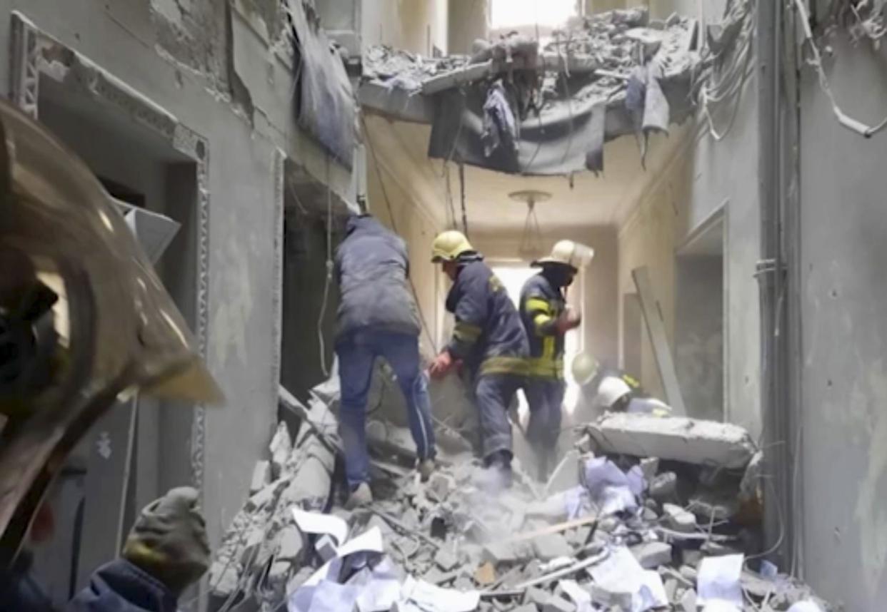 In this frame from a footage released by the State service of special communication and information protection of Ukraine, firemen work inside the regional administration building in the city's central square of Kharkiv, Ukraine, after Russian shelling, Tuesday, March 1, 2022. Russian shelling pounded civilian targets in Ukraine's second-largest city, Kharkiv, Tuesday and a 40-mile convoy of tanks and other vehicles threatened the capital, tactics Ukraine's embattled president said were designed to force him into concessions in Europe's largest ground war in generations.