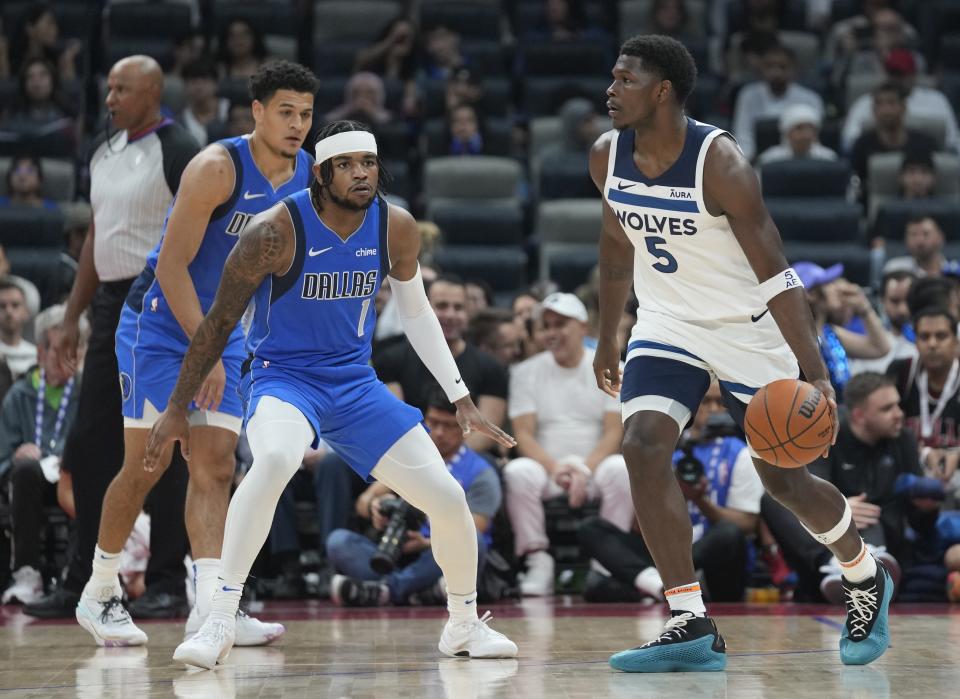 Minnesota Timberwolves' Anthony Edwards dribble the ball during a preseason NBA basketball game between the Dallas Mavericks and Minnesota Timberwolves in Abu Dhabi, United Arab Emirates in Abu Dhabi, United Arab Emirates, Saturday, Oct. 7, 2023. (AP Photo/Kamran Jebreili)