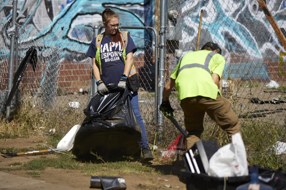 THIS CORRECTS THE NAME OF THE CONTRACTOR TO RAPID RESPONSE BIO CLEAN, NOT RAPID RESPONSE BIO CLEANUP AS ORIGINALLY SENT - Amber Nastasia from Rapid Response Bio Clean cleans a homeless camp in Portland, Ore., Thursday, July 27, 2023. Cities across the U.S. are struggling with and cracking down on tent encampments as the number of homeless people grows, largely due to a lack of affordable housing. Homeless people and their advocates say sweeps are cruel and costly, and there aren't enough homes or beds for everyone. (AP Photo/Craig Mitchelldyer)