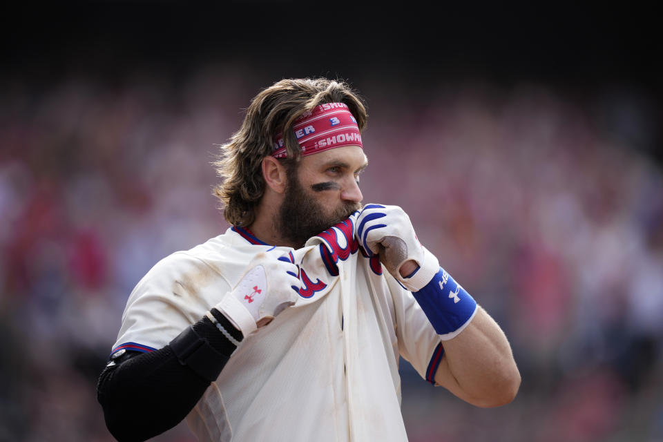 Philadelphia Phillies' Bryce Harper kisses his jersey after hitting a two-run home run during the eighth inning of a baseball game against the Los Angeles Angels, Wednesday, Aug. 30, 2023, in Philadelphia. (AP Photo/Matt Slocum)