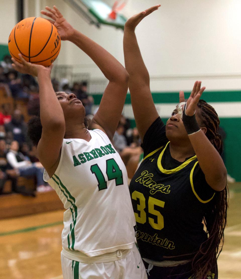 Ashbrook's Emerald Butler tries to lift a shot as Kings Mountain's Tyasa Bell defends during Friday's game in Gastonia.