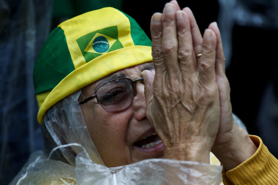A supporter of President Jair Bolsonaro prays during a protest against his defeat in the presidential runoff election, in Rio de Janeiro, Brazil, Wednesday, Nov. 2, 2022. Thousands of supporters called on the military Wednesday to keep the far-right leader in power, even as his administration signaled a willingness to hand over the reins to his rival Luiz Inacio Lula da Silva. (AP Photo/Bruna Prado)