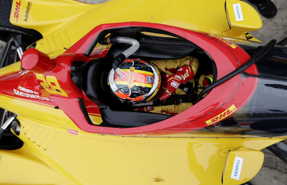 IndyCar driver Ryan Hunter-Reay adjusts his helmet as he prepares to drive in IndyCar Series Open Testing, Wednesday, Feb. 12, 2020, in Austin, Texas. (AP Photo/Eric Gay)