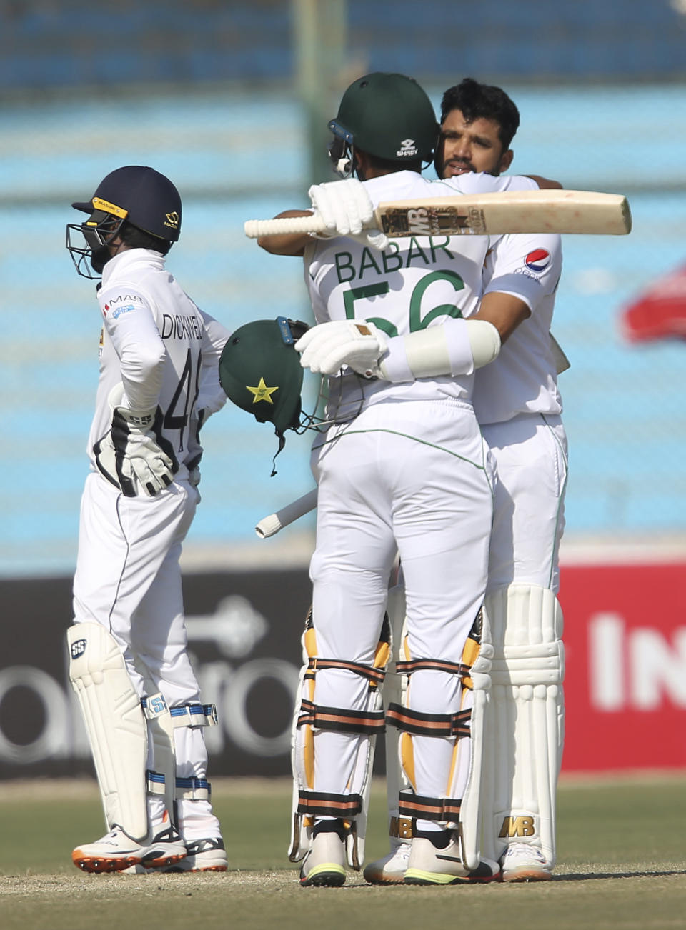 Pakistani batsman Babar Azam greets Azhar Ali for his 100 against Sri Lanka during the second Test in Karachi, Pakistan, Sunday, Dec. 22, 2019. (AP Photo/Fareed Khan)