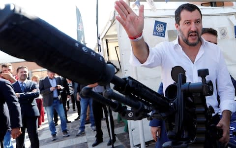 Italian Interior Minister Salvini has been accused by opponents of burnishing his 'tough guy' image again - here he poses in October 2018 with a sniper rifle during a visit to celebrate the anniversary of the Central Security Operations Service (NOCS), a SWAT team of the Polizia di Stato in Rome - Credit: Reuters