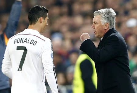 Real Madrid's coach Carlo Ancelotti (R) talks to Cristiano Ronaldo during their Champions League Group B soccer match against FC Basel at St. Jakob-Park stadium in Basel November 26, 2014. REUTERS/Arnd Wiegmann