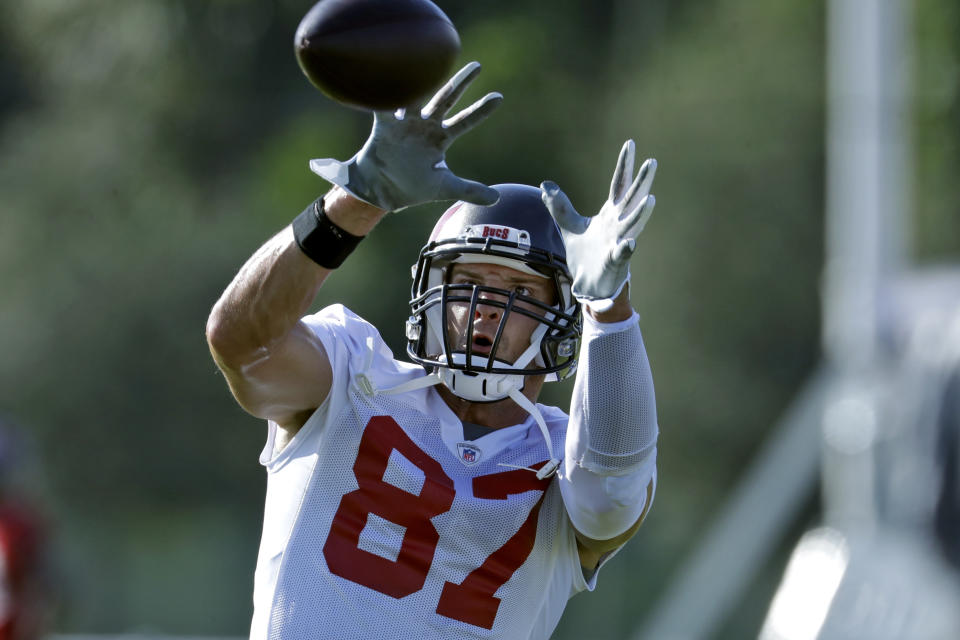 FILE - In this Aug. 13, 2020, file photo, Tampa Bay Buccaneers tight end Rob Gronkowski (87) catches a pass during an NFL football organized team activity in Tampa, Fla. A refreshed Rob Gronkowski is back on the practice field with Tom Brady, sweating in the hot Florida sun, preparing for their first season with the Tampa Bay Buccaneers. And, he is loving every minute of it. (AP Photo/Chris O'Meara, File)