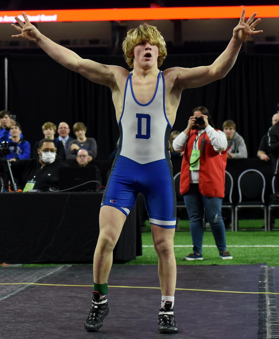 Casey Swiderski of Dundee holds up the number four after winning his fourth Division 3 state title in the MHSAA finals Saturday, March 5, 2022 at Ford Field in Detroit after he pinned Aidan Shier of Kingsley in the second period. Swiderski was also part of the D3 championship team who recently won there fifth straight title.