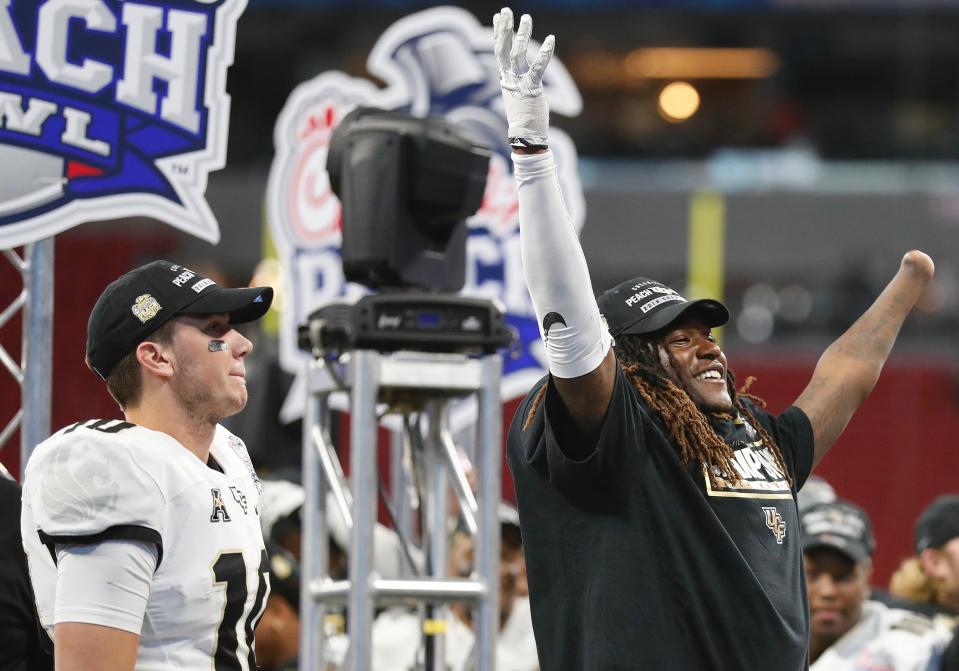 UCF’s one-handed All-AAC linebacker Shaquem Griffin celebrates the Peach Bowl win with QB McKenzie Milton. (AP)