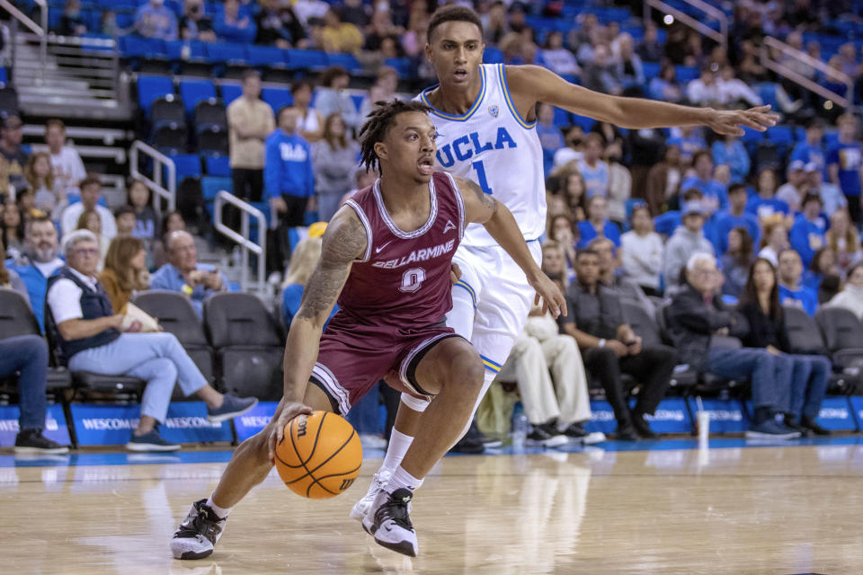 Bellarmine guard Jaylen Fairman, left, drives past UCLA guard Abramo Canka to the basket during the first half of an NCAA college basketball game in Los Angeles, Sunday, Nov. 27, 2022. (AP Photo/Alex Gallardo)