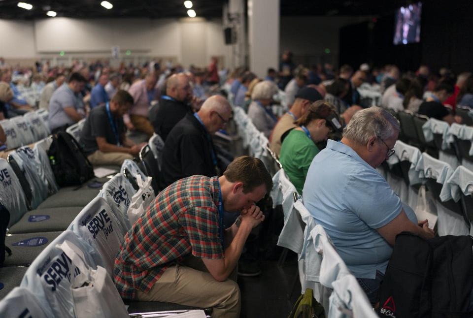 <span class="caption">Attendees pray during a worship service at the Southern Baptist Convention's annual meeting in Anaheim, California, on June 14, 2022.</span> <span class="attribution"><a class="link " href="https://newsroom.ap.org/detail/SouthernBaptists/be5739958c124002a67604c14f29ec0b/photo?Query=southern%20baptist%20convention&mediaType=photo&sortBy=&dateRange=Anytime&totalCount=425&currentItemNo=13" rel="nofollow noopener" target="_blank" data-ylk="slk:AP Photo/Jae C. Hong">AP Photo/Jae C. Hong</a></span>