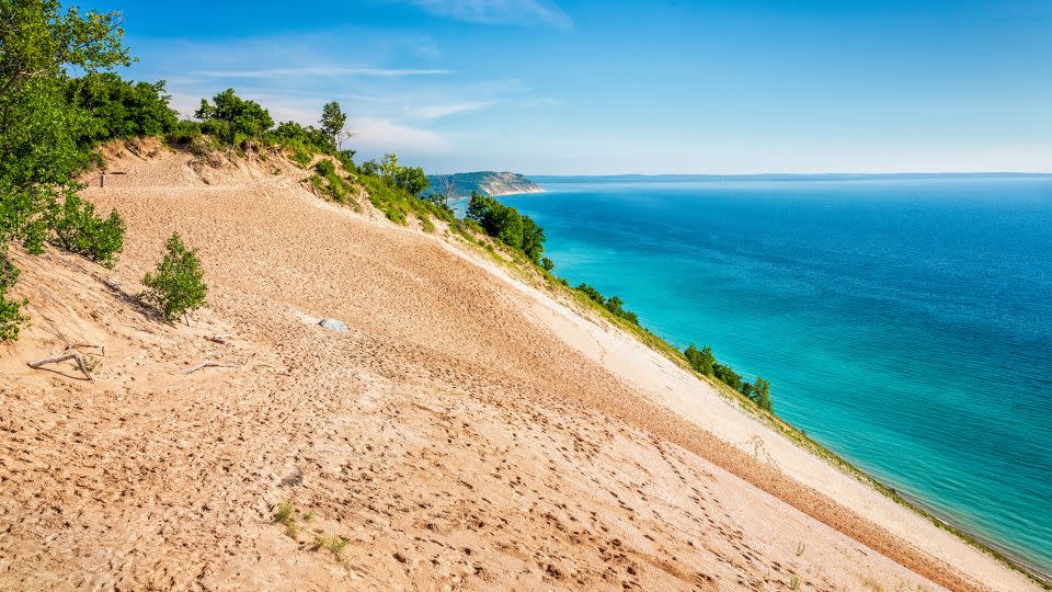 Sleeping Bear Dunes National Lakeshore boasts a number of scenic hikes, including a strenuous one over the towering dunes that leads to Lake Michigan. - Deb Snelson/Moment RF/Getty Images