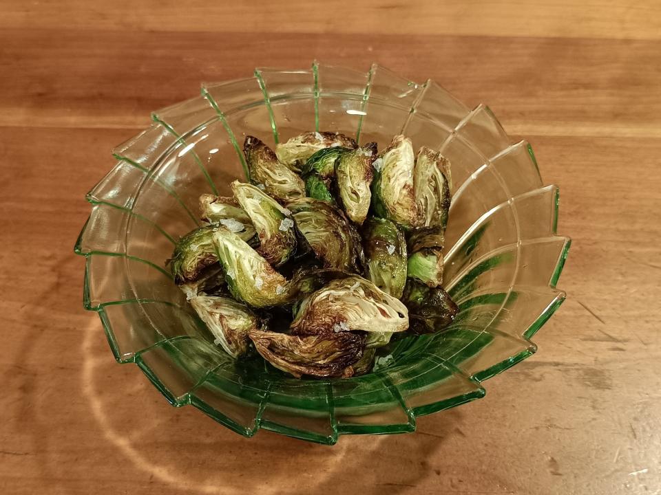 Brussels sprouts in a small green bowl