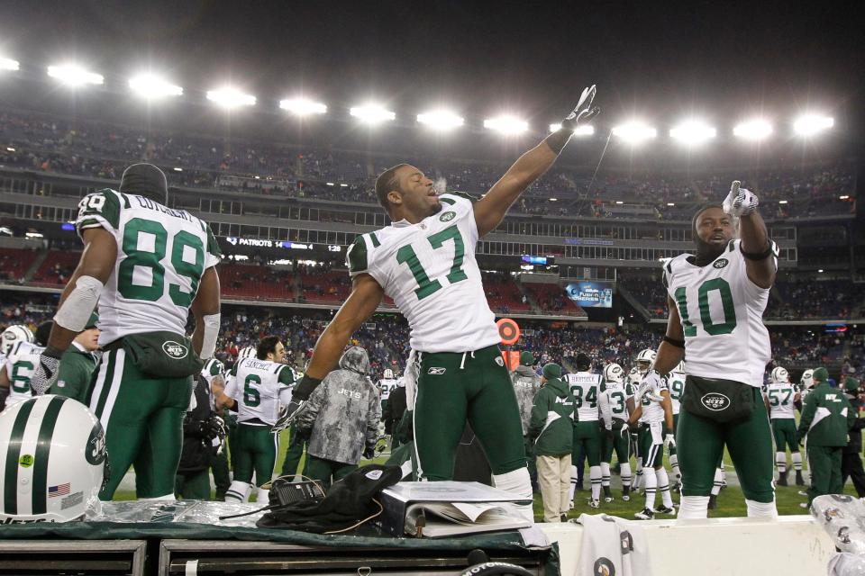 New York Jets wide receiver Braylon Edwards (17), wide receiver Santonio Holmes (10) and wide receiver Jerricho Cotchery (89) celebrate during the last seconds of play against the New England Patriots in the 2011 AFC divisional playoff game at Gillette Stadium.