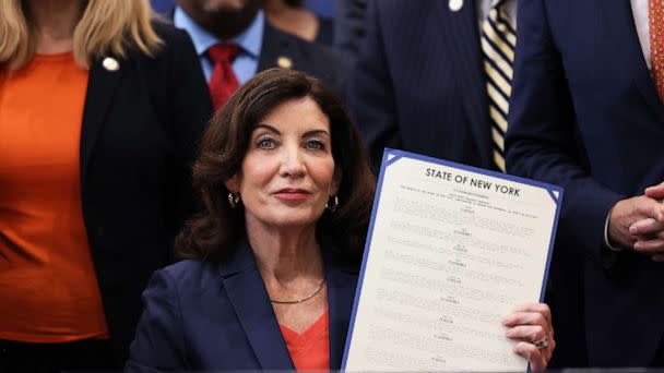 PHOTO: Gov. Kathy Hochul holds up signed legislation as she is surrounded by lawmakers during a bill signing ceremony at the Northeast Bronx YMCA in New York, June 06, 2022. (Michael M. Santiago/Getty Images, FILE)