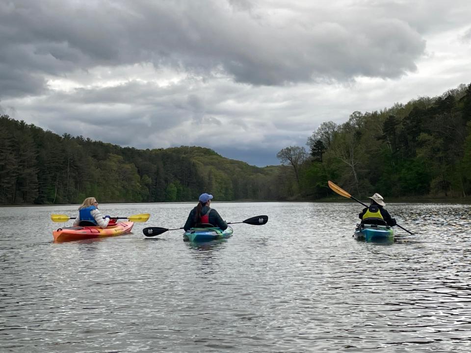 Kayakers on a paddle with Touch the Earth Adventures watch as beautiful but ominous clouds move, fortuitously, away from the lake.