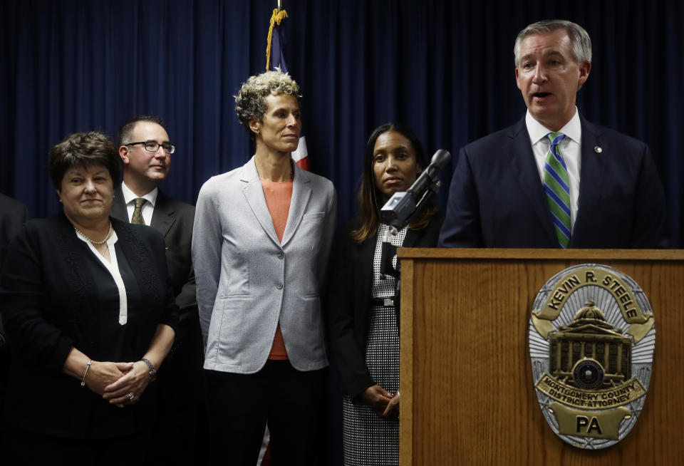 Accuser Andrea Constand, center, stands behind Montgomery County District Attorney Kevin Steele, right, at a news conference after Bill Cosby was sentenced to three-to 10-years for sexual assault Tuesday, Sept. 25, 2018, in Norristown, Pa. (AP Photo/Matt Slocum)