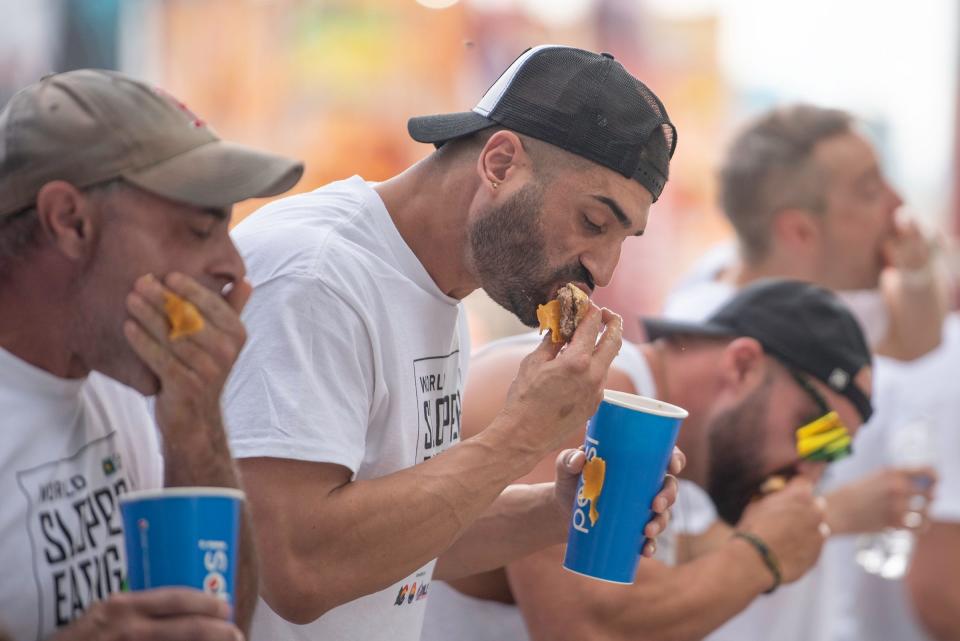 James Webb forces down one of the 32 sloppers that made him the 2023 World Slopper Eating Champion at the Colorado State Fair in Pueblo on Saturday, September 1, 2023.