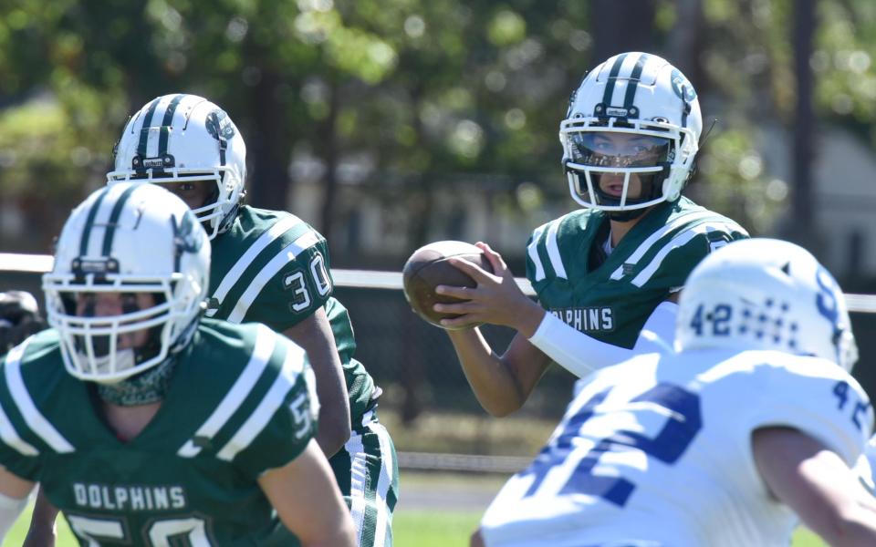 SOUTH YARMOUTH 9/24/22 D-Y quarterback Jayden Barber looks for an open receiver upfield as Dennis-Yarmouth  High School played host to Stoneham High in  Saturday afternoon football action. 