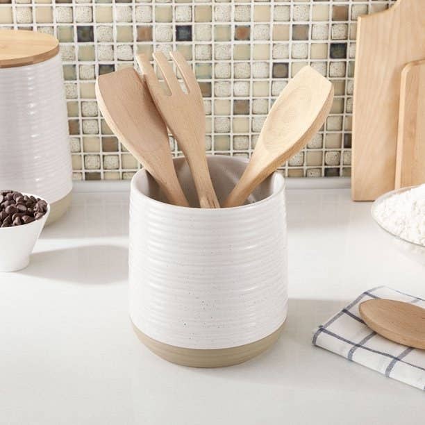 Utensil holder with wooden spoons in it