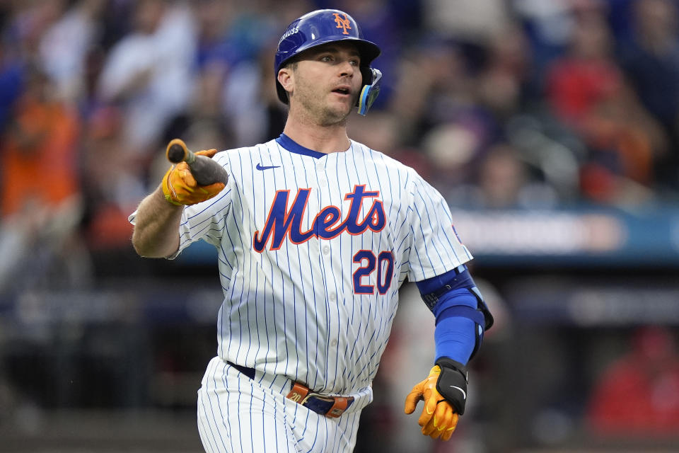 New York Mets' Pete Alonso (20) tosses his bat as he watches his solo home run sail over the right field wall against the Philadelphia Phillies during the second inning of Game 3 of the National League baseball playoff series, Tuesday, Oct. 8, 2024, in New York. (AP Photo/Frank Franklin II)