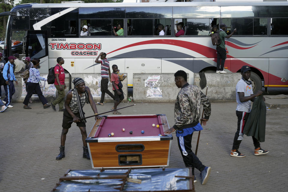 People play pool in an open space in Harare, Zimbabwe, Wednesday, Nov. 30, 2022. Previously a minority and elite sport in Zimbabwe, the game has increased in popularity over the years, first as a pastime and now as a survival mode for many in a country where employment is hard to come by. (AP Photo/Tsvangirayi Mukwazhi)