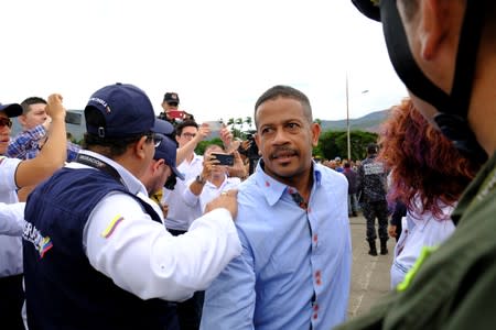 Colombian citizen walks past Colombian migration officials at the Simon Bolivar International Bridge