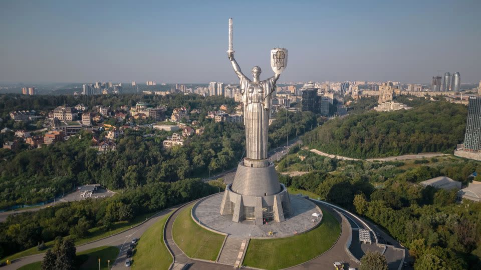 The steel statue, pictured with the Ukrainian coat of arms on Sunday, is an imposing feature of Kyiv's skyline.  - Roman Pilipey/AFP/Getty Images