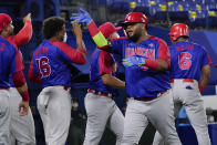 Dominican Republic's Juan Francisco celebrates with teammates his home run in the fourth inning of a baseball game against South Korea at the 2020 Summer Olympics, Sunday, Aug. 1, 2021, in Yokohama, Japan. (AP Photo/Sue Ogrocki)