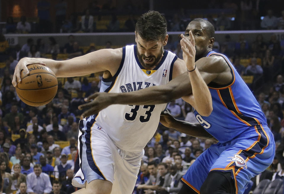 Memphis Grizzlies center Marc Gasol (33) drives against Oklahoma City Thunder forward Serge Ibaka during the first half of Game 3 of an opening-round NBA basketball playoff series Thursday, April 24, 2014, in Memphis, Tenn. (AP Photo/Mark Humphrey)