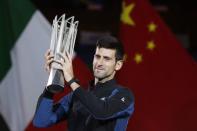 Tennis - Shanghai Masters - Men's Singles - Qi Zhong Tennis Center, Shanghai, China - October 14, 2018. Novak Djokovic of Serbia celebrates with the trophy after winning the final against Borna Coric of Croatia. REUTERS/Aly Song