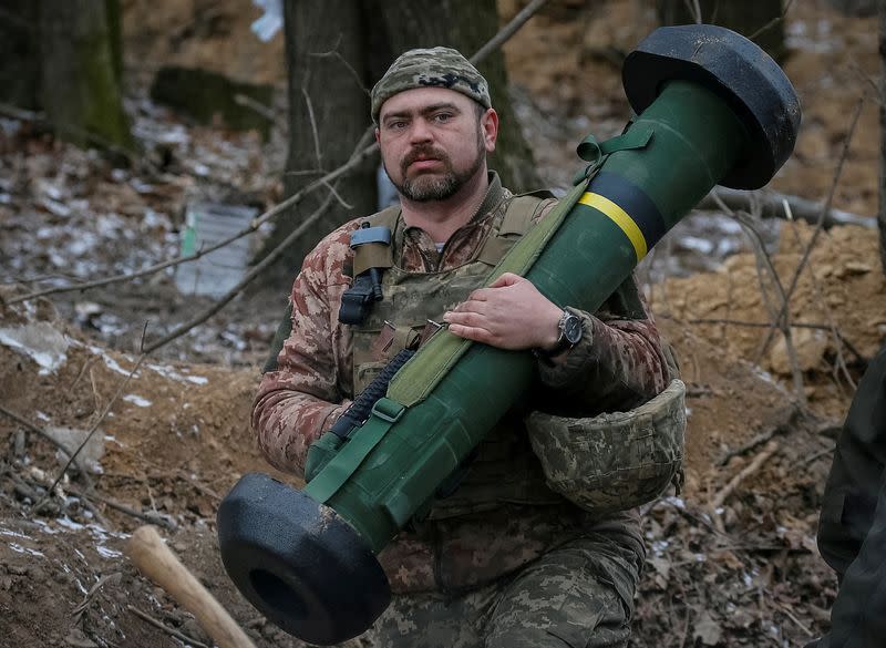 FILE PHOTO: Ukrainian service member holds a Javelin missile system at a position on the front line in the north Kyiv region