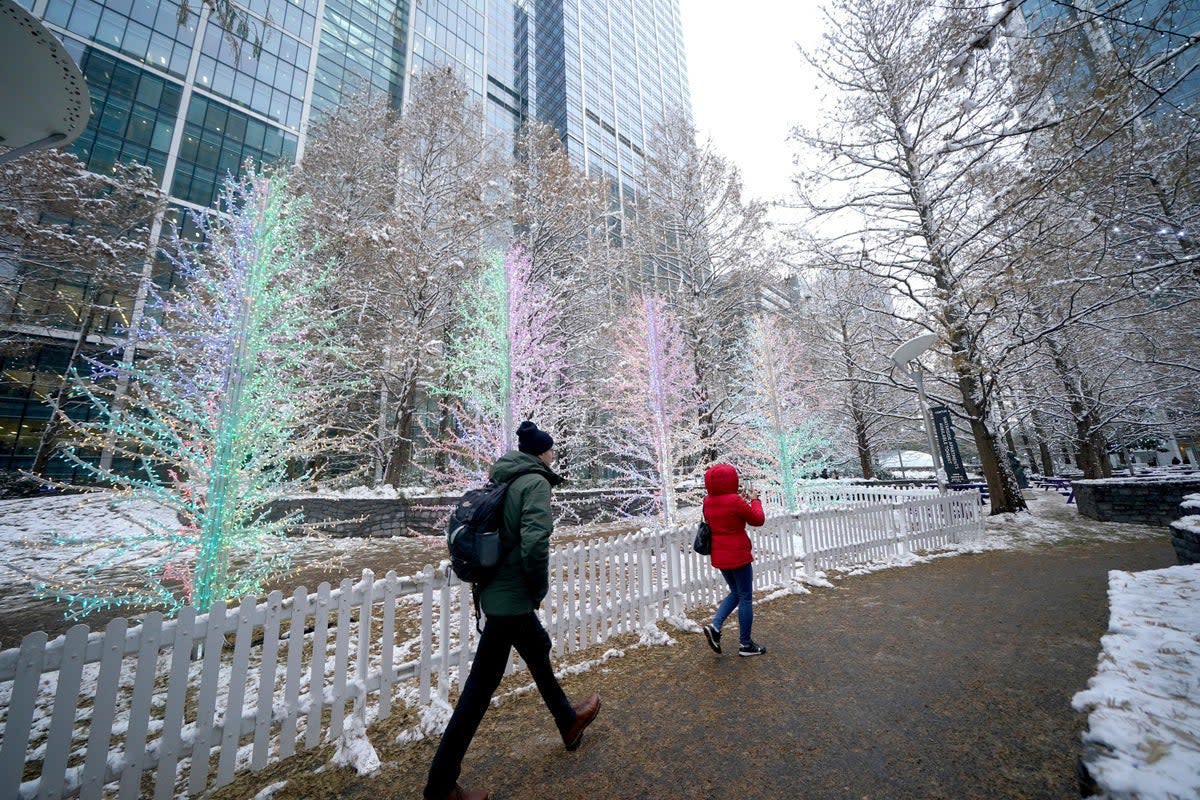 People walk during a cold snap in Canary Wharf (PA Wire)