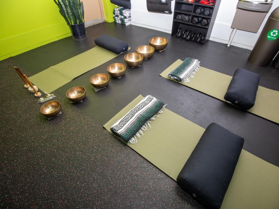 Inside Roam149's gym with yoga mats, weights.