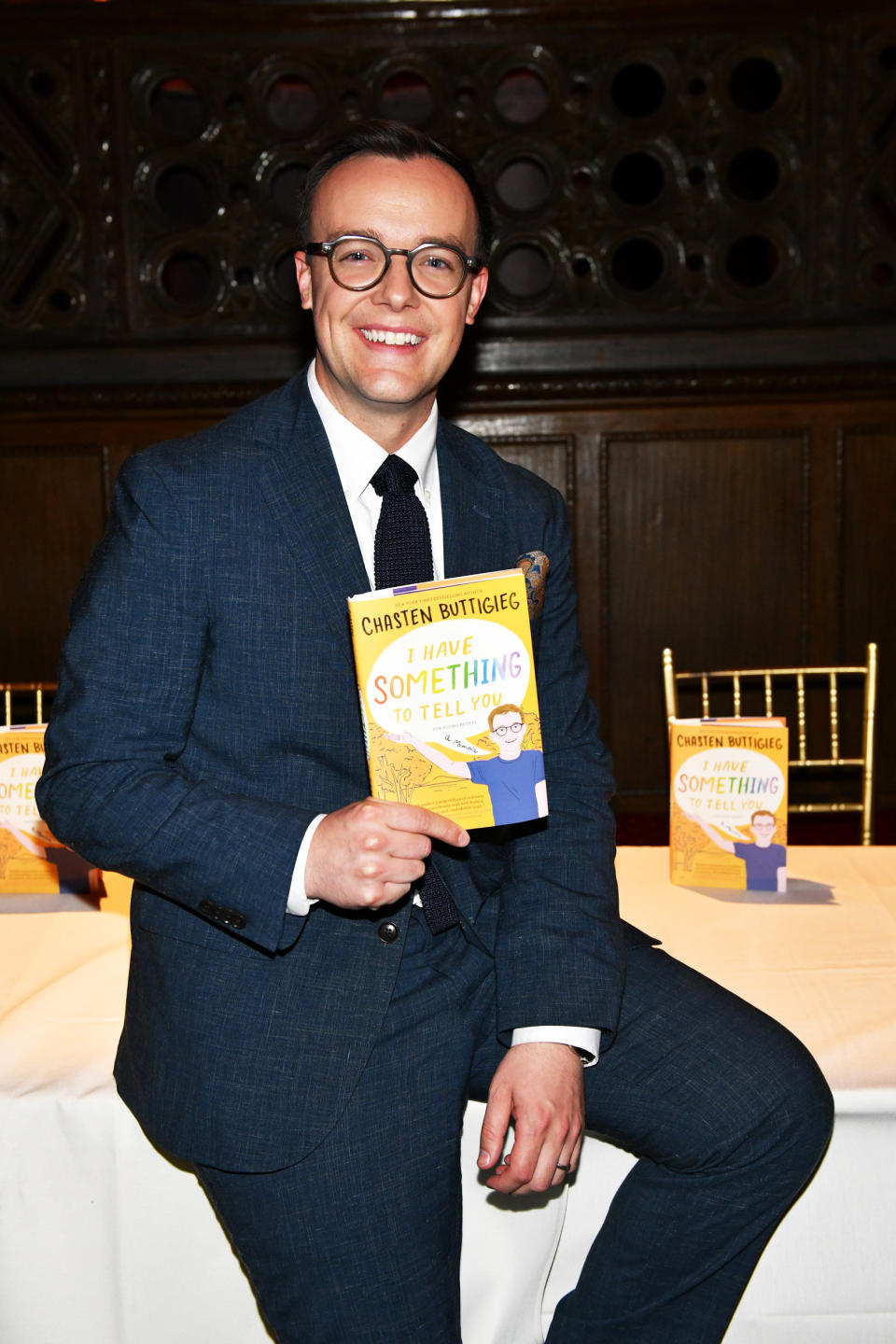 Chasten Buttigieg holds his book, 