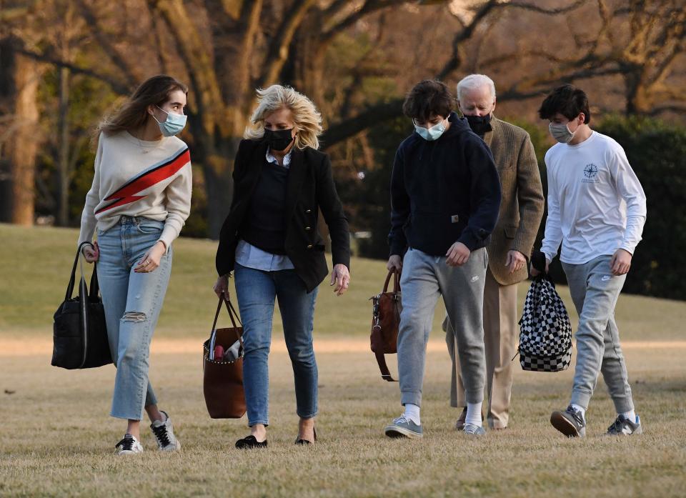 A familiar scene for first lady Jill Biden and President Joe Biden: Surrounded by grandchildren and their friends as they walk across the South Lawn on return to the White House from a weekend at their Wilmington, Del., home, March 14, 2021. Shown are Natalie Biden (L), Hunter Biden (3R), and a friend.