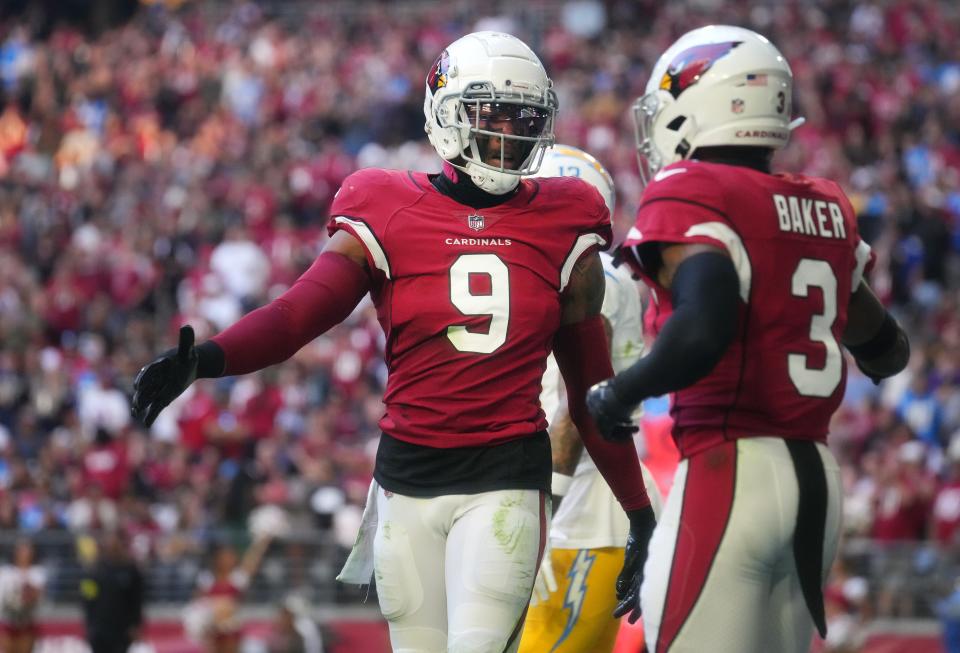 Nov 27, 2022; Glendale, AZ, USA; Arizona Cardinals defenders Budda Baker (3) and Isaiah Simmons (9) celebrate a defensive stop against the Los Angeles Chargers at State Farm Stadium. Mandatory Credit: Joe Rondone-Arizona Republic