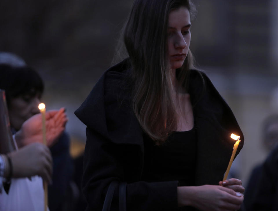 A woman holds a candle during a vigil for Bulgarian journalist Viktoria Marinova, killed in the northern town of Ruse, in Sofia, Monday, Oct. 8, 2018. Bulgarian police are investigating the rape, beating and slaying of a female television reporter whose body was dumped near the Danube River after she reported on the possible misuse of European Union funds in Bulgaria. (AP Photo/Valentina Petrova)