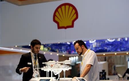 FILE PHOTO: Staff members work at the booth of Royal Dutch Shell at Gastech, the world's biggest expo for the gas industry, in Chiba, Japan, April 4, 2017. REUTERS/Toru Hanai/File Photo