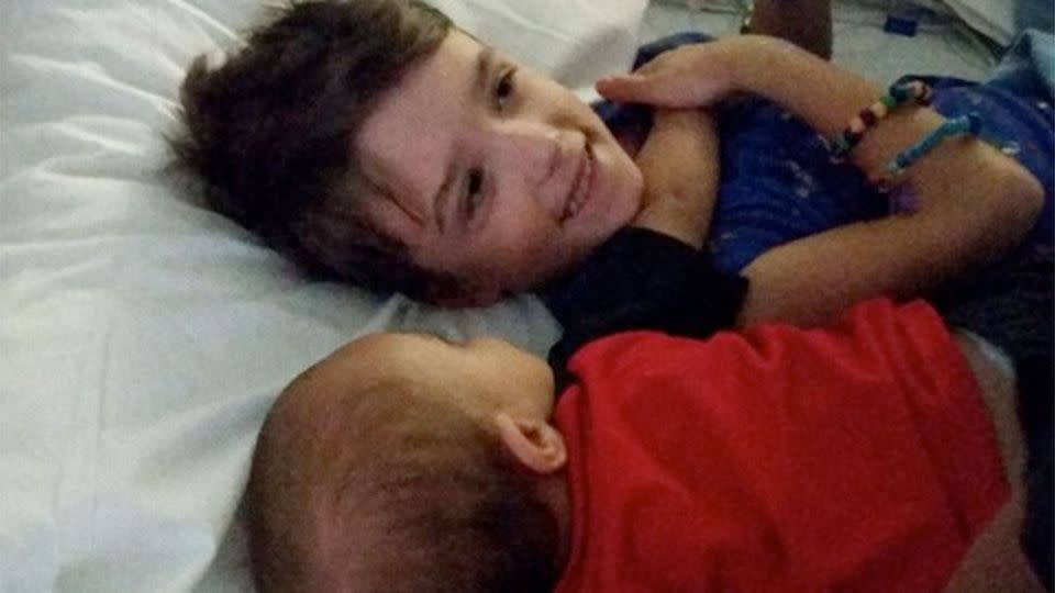 Leland had a little brother and can be seen hugging him in a hospital bed. Photo: Leland's GoFundMe page